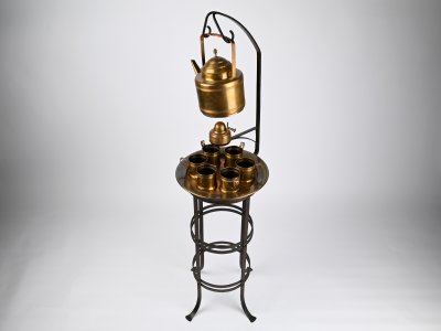 AN ART NOUVEAU STAND WITH A TEA SET