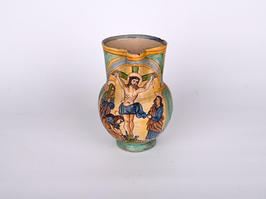 A CERAMIC JAR WITH CRUCIFIX