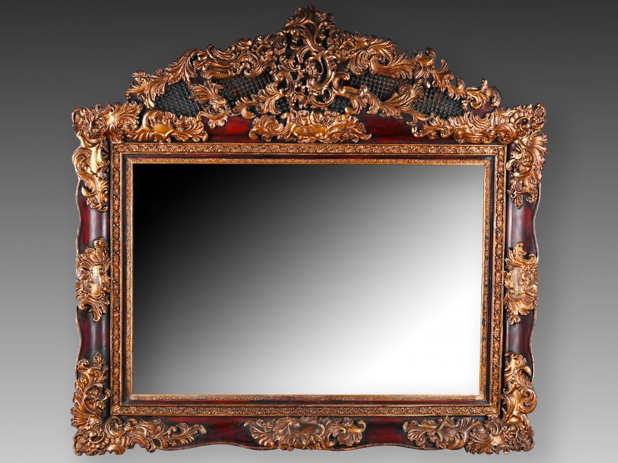 A RICHLY DECORATED ROCOCO STYLE PICTURE FRAME