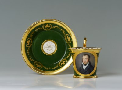 A PORTRAIT CUP AND SAUCER