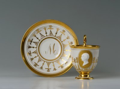 A CUP AND SAUCER WITH A PORTRAIT MEDALLION