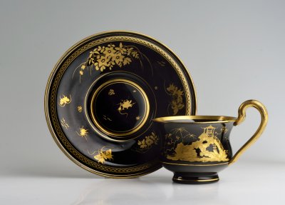 BLACK HYALITE GLASS - CUP AND SAUCER WITH CHINOISERIE MOTIFS