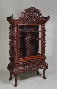 A RICHLY CARVED CHINESE VITRINE