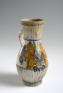 A PAIR OF TWO FOLK ART PITCHERS WITH FLOWER MOTIFS AND STAG