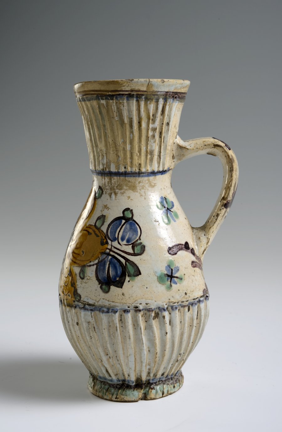 A PAIR OF TWO FOLK ART PITCHERS WITH FLOWER MOTIFS AND STAG