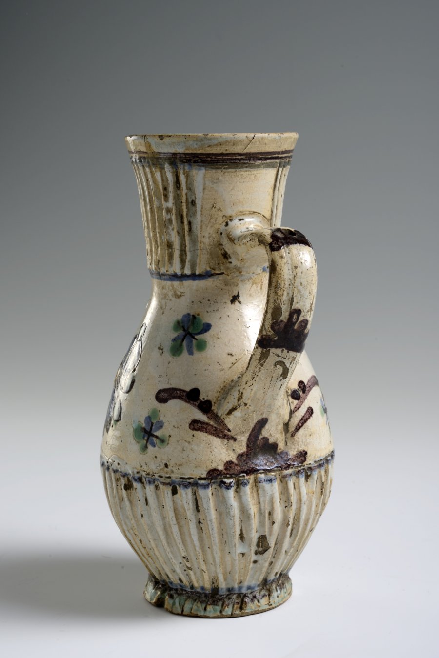 A PAIR OF TWO FOLK ART PITCHERS WITH FLOWER MOTIFS AND STAG