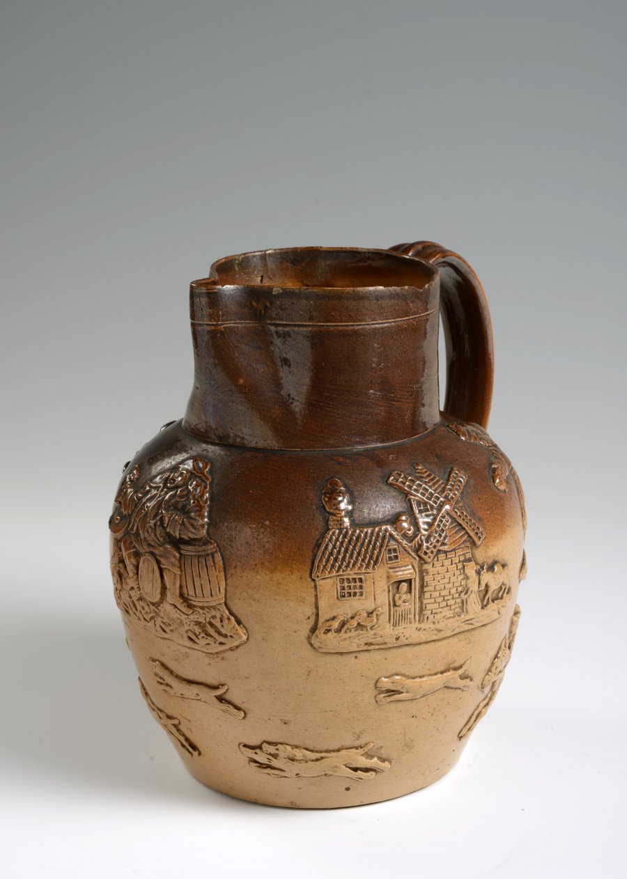 A SALT GLAZED PITCHER WITH HUNTING MOTIFS