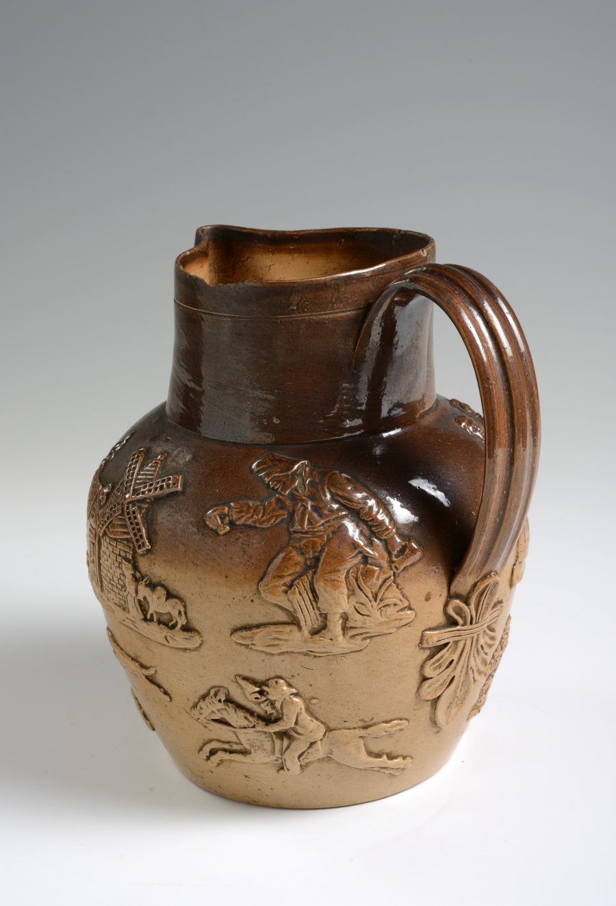 A SALT GLAZED PITCHER WITH HUNTING MOTIFS