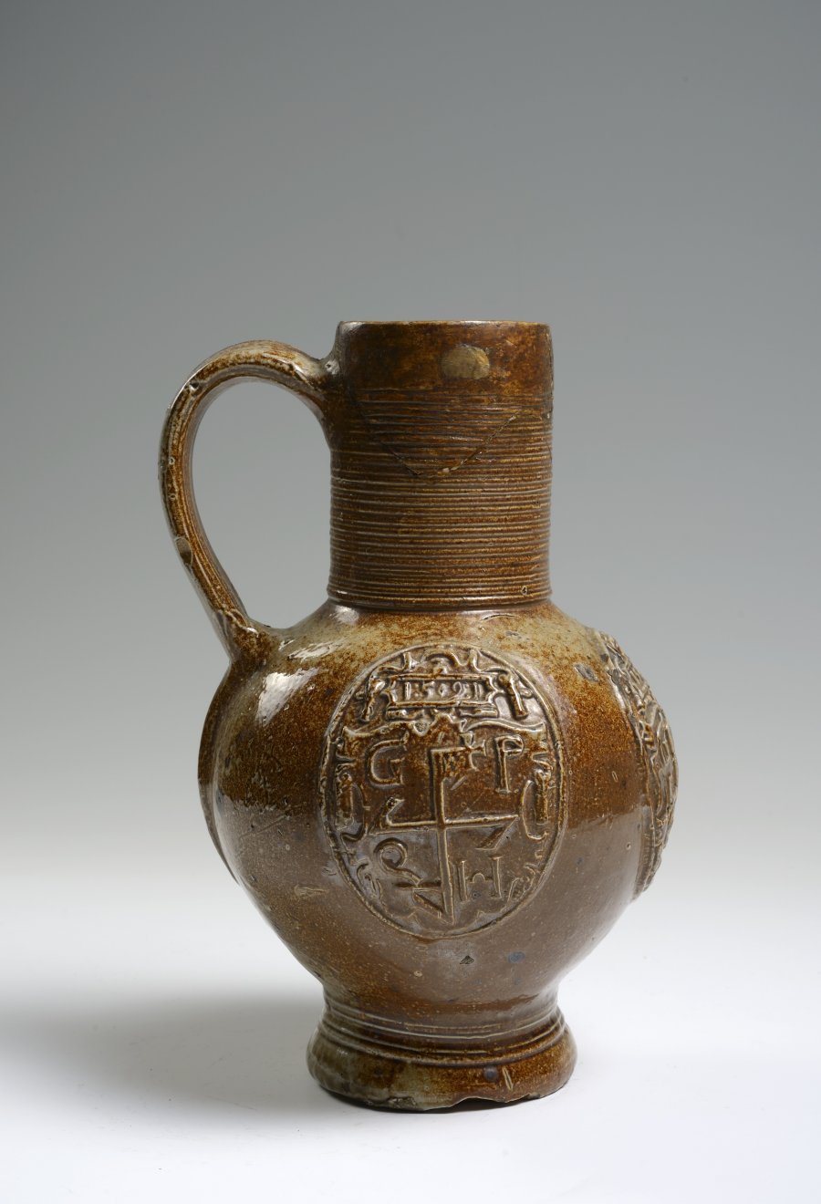 A SALT GLAZED PITCHER WITH RELIEFS