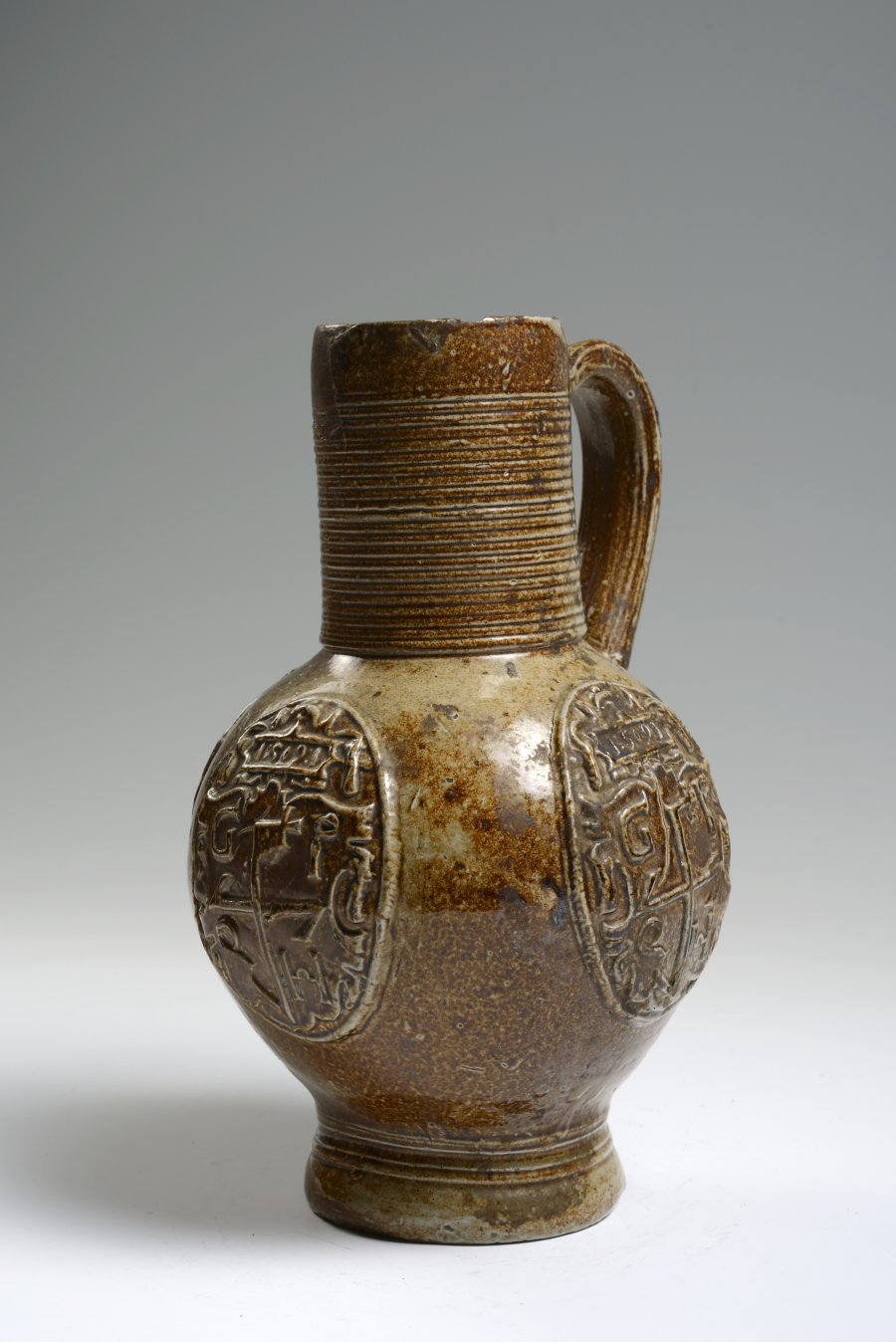 A SALT GLAZED PITCHER WITH RELIEFS