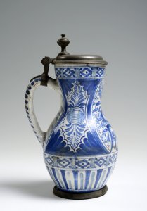 A FAÏENCE PITCHER WITH PEWTER MOUNTS