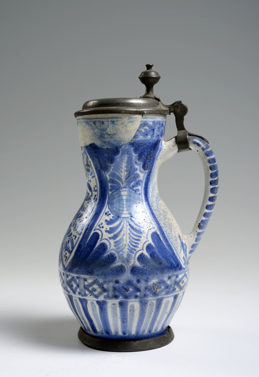 A FAÏENCE PITCHER WITH PEWTER MOUNTS