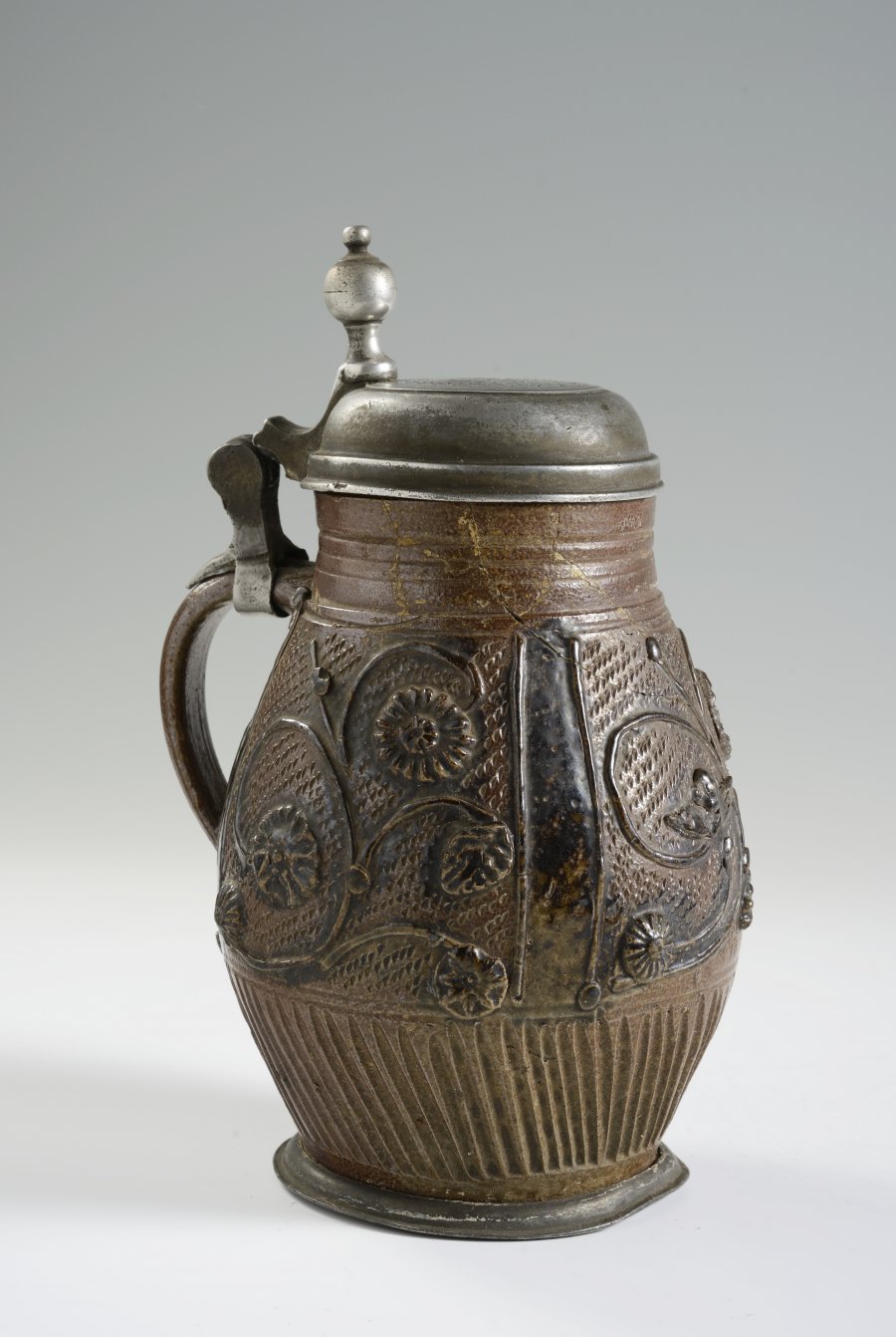 A STONEWARE PITCHER WITH PEWTER MOUNTS