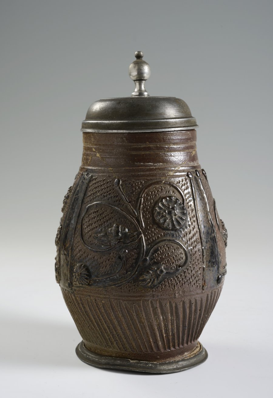 A STONEWARE PITCHER WITH PEWTER MOUNTS