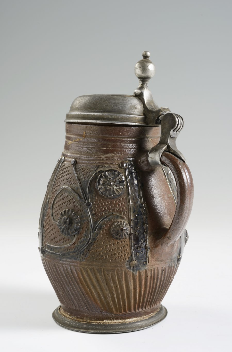 A STONEWARE PITCHER WITH PEWTER MOUNTS