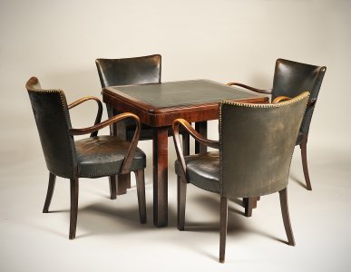 A CARD TABLE WITH FOUR CHAIRS