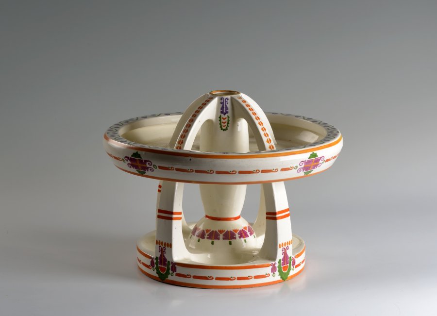 A CAKE STAND WITH A BOWL AND VASE