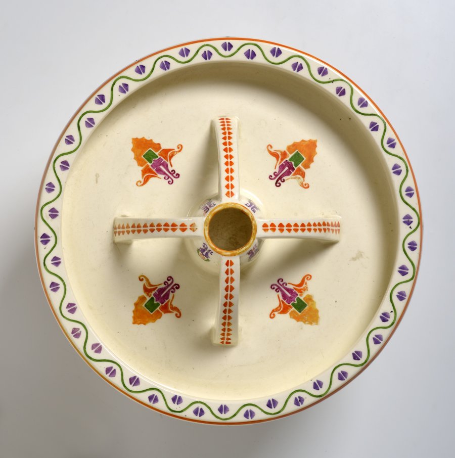 A CAKE STAND WITH A BOWL AND VASE