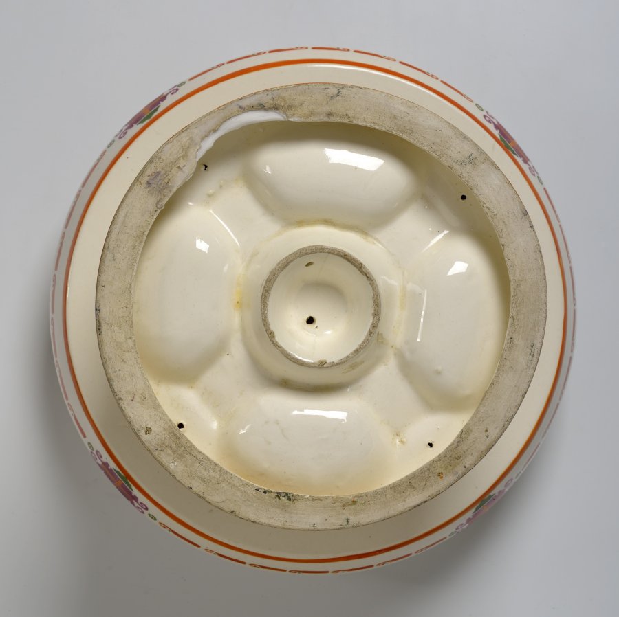 A CAKE STAND WITH A BOWL AND VASE