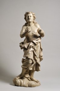 A BAROQUE WOOD CARVING OF A STANDING CUPID