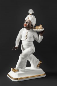 PORCELAIN STATUE OF A MOOR WITH TURKEY