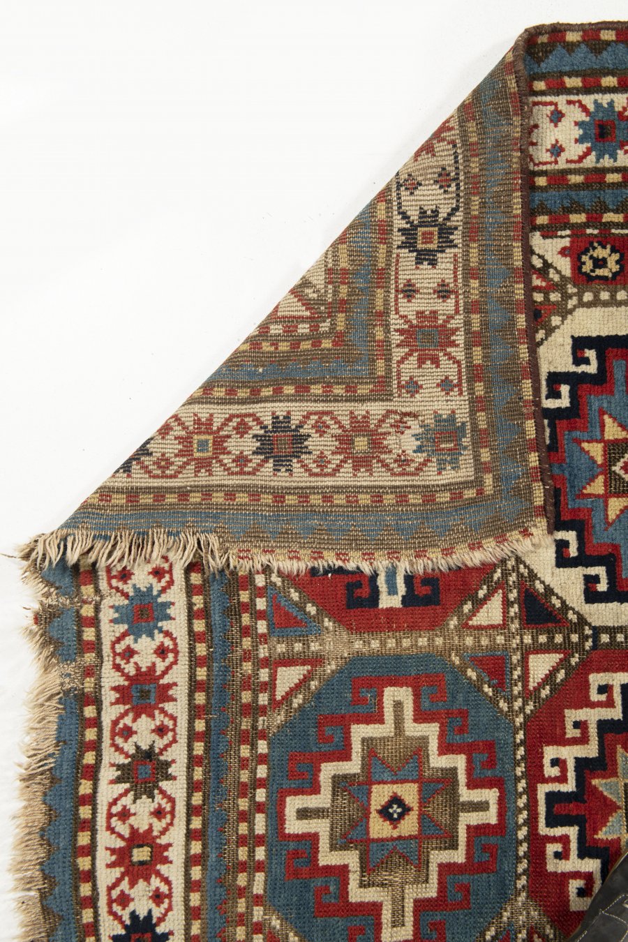 AN ANTIQUE MOGHAN KAZAK RUG