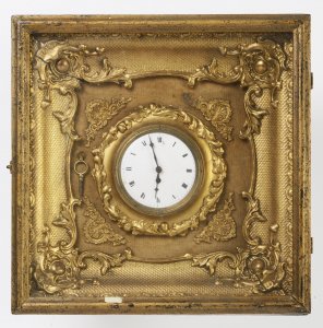 A MINIATURE GILDED PICTURE FRAME CLOCK