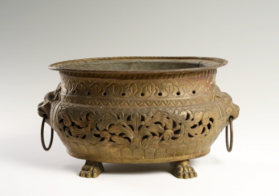 A CAST BRASS FLOWERPOT WITH LION HEADS