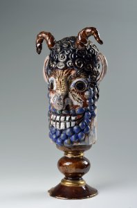 A CERAMIC DEVIL'S HEAD 