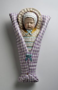 A CHILD IN SWADDLING